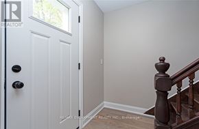 Norfolk (Townsend) apartment for rent - A white door with a black handle and a wooden staircase.