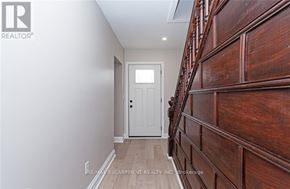 Norfolk (Townsend) apartment for rent - A hallway with a white door and wooden staircase.