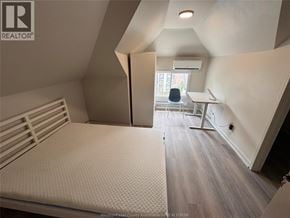 Windsor apartment for rent - A bedroom with a bed, desk, and chair.
