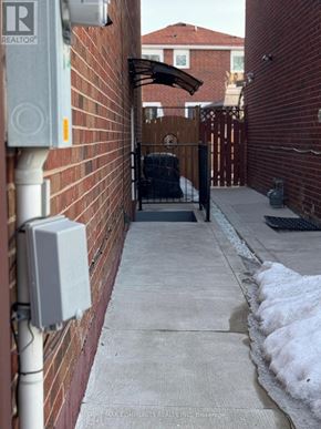 Toronto (Rouge) apartment for rent - A white electrical box is mounted on a red brick wall.
