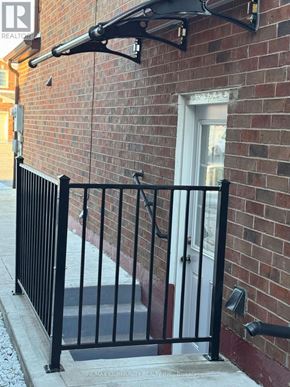 Toronto (Rouge) apartment for rent - A black metal fence with a sign that says REMAX COMMUNITY BUILT INSURANCE.