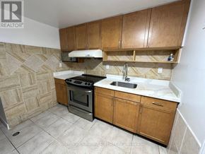 Markham (Middlefield) apartment for rent - A kitchen with wooden cabinets and a tiled floor.