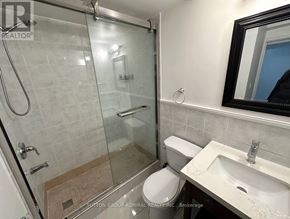 Markham (Middlefield) apartment for rent - A bathroom with a toilet, sink, and glass shower stall.