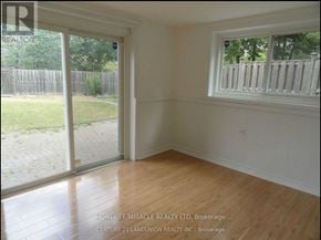 Toronto (L'amoreaux) apartment for rent - A room with a window and sliding glass doors leading to a backyard.