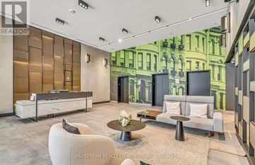 Markham (Unionville) condo for rent - A modern living room with a grey sofa and a coffee table.