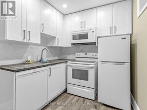 Toronto (Stonegate-Queensway) apartment for rent - A kitchen with white appliances and cabinets.