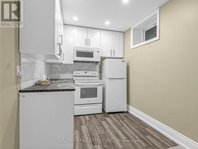 Toronto (Stonegate-Queensway) apartment for rent - A kitchen with white appliances and a granite countertop.