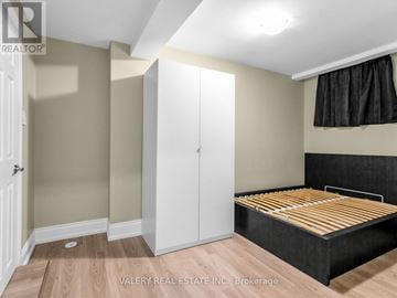Toronto (Stonegate-Queensway) apartment for rent - A bedroom with a bed, wardrobe and cupboard.