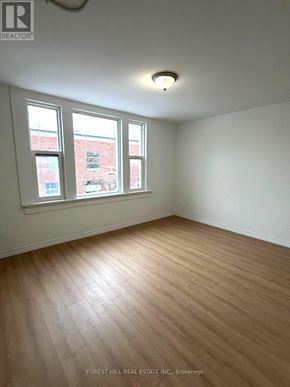 Kitchener apartment for rent - A room with wooden flooring and two windows.