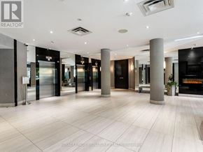 Toronto (Willowdale East) condo for rent - A lobby with a white ceiling and a sign that says "REALTOR".