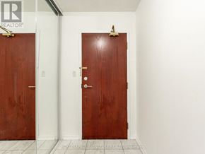 Toronto (Willowdale East) condo for rent - Two brown doors in a white hallway.