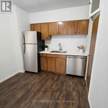 Toronto (Moss Park) apartment for rent - A kitchen with a refrigerator, sink, and cabinets.