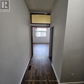 Toronto (Moss Park) apartment for rent - A hallway with wood floors and a window with yellow blinds.