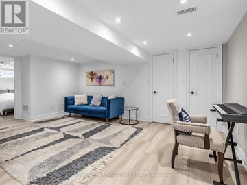 Toronto (Wexford-Maryvale) apartment for rent - A living room with a blue couch and a rug.