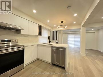 Toronto (Milliken) apartment for rent - A modern kitchen with white cabinets and stainless steel appliances.
