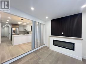 Toronto (Milliken) apartment for rent - A modern kitchen with a fireplace in the living room.