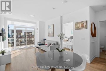 Innisfil condo for rent - A modern living room with a glass table and white furniture.