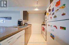 Toronto (Eglinton East) condo for rent - A kitchen with a refrigerator covered in magnets.