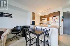 Toronto (Eglinton East) condo for rent - A modern kitchen with a dining table and chairs.