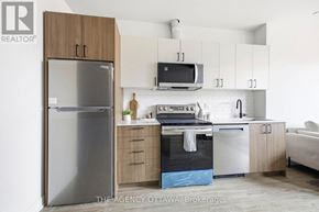 Ottawa condo for rent - A modern kitchen with a refrigerator, oven, and microwave.