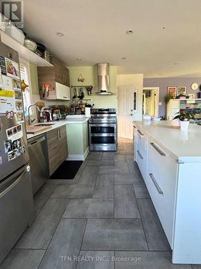 Toronto (Alderwood) apartment for rent - A kitchen with a refrigerator covered in magnets.