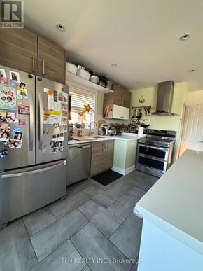 Toronto (Alderwood) apartment for rent - A kitchen with a refrigerator covered in magnets.