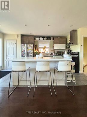 Toronto (Alderwood) apartment for rent - A kitchen with white chairs and a white table.
