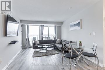 Toronto (Parkwoods-Donalda) condo for rent - A modern living room with a glass table and chairs.
