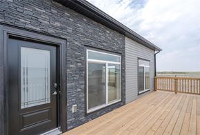 Mitchell apartment for rent - A house with a black door and a wooden deck.