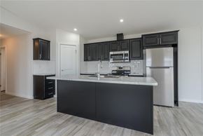 Mitchell apartment for rent - A modern kitchen with black cabinets and stainless steel appliances.