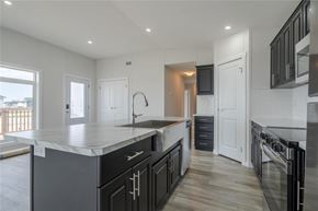 Mitchell apartment for rent - A modern kitchen with black cabinets and a large island.