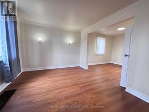 Toronto (Newtonbrook East) apartment for rent - A room with wooden floors and white walls.