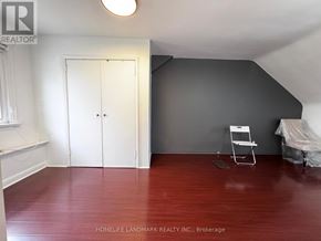 Toronto (Newtonbrook East) apartment for rent - A room with a wooden floor and a white door.