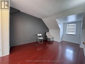 Toronto (Newtonbrook East) apartment for rent - A room with wooden floors and a window with shutters.