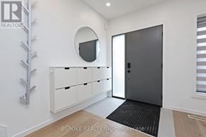 Toronto (Danforth Village-East York) apartment for rent - A white hallway with a round window and a black door.