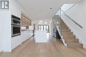 Toronto (Danforth Village-East York) apartment for rent - A spacious kitchen with a staircase leading to the upper floor.
