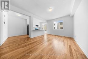 Ottawa townhouse for rent - A room with wooden flooring and white walls, with a window letting in natural light.