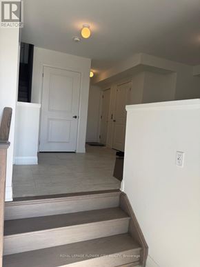 Clarington (Bowmanville) townhouse for rent - A white door is in a hallway with a light on the ceiling.