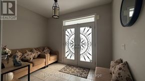 Shelburne apartment for rent - A living room with a couch, a coffee table, and a door with a glass window.