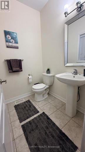 Shelburne apartment for rent - A bathroom with a toilet, sink, and mirror.