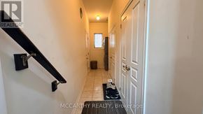 Shelburne apartment for rent - A hallway with a black railing and white walls.