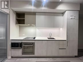 Vaughan (Vaughan Corporate Centre) condo for rent - A modern kitchen with white cabinets and stainless steel appliances.