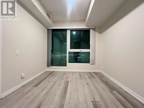 Vaughan (Vaughan Corporate Centre) condo for rent - A room with a sliding glass door and wooden flooring.
