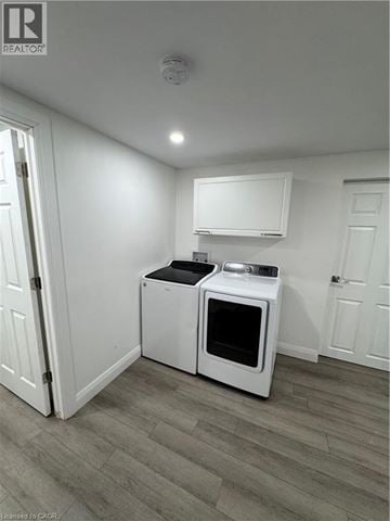 Kitchener apartment for rent - A white microwave oven and a white toaster oven are on a counter in a kitchen.