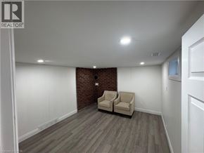 Kitchener apartment for rent - A room with a brick wall and two chairs.