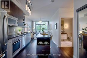 Toronto (Willowdale East) condo for rent - A modern kitchen with stainless steel appliances and a view of the backyard.