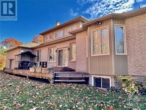 Ottawa apartment for rent - A house with a deck and a patio is surrounded by fallen leaves.