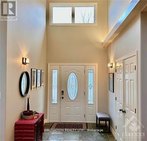 Ottawa apartment for rent - A hallway with a bench, a table, and a door with a glass window.