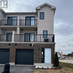 Stratford townhouse for rent - A two-story building with a balcony and a garage door.