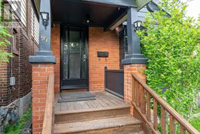 Toronto (Birchcliffe-Cliffside) apartment for rent - A house numbered 97 has a black front door and a wooden porch.